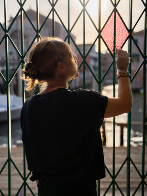 Alice Rose Archer in front of one of the gates created as part of Alberta Whittle's Venice exhibition, deep dive (pause) uncoiling memory. Image credit: Joe Satorius