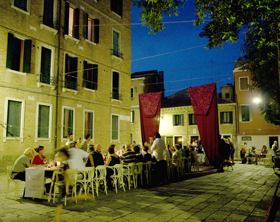 Large group of people dining outdoors in Italy